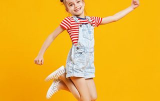 photo of young child jumping for joy